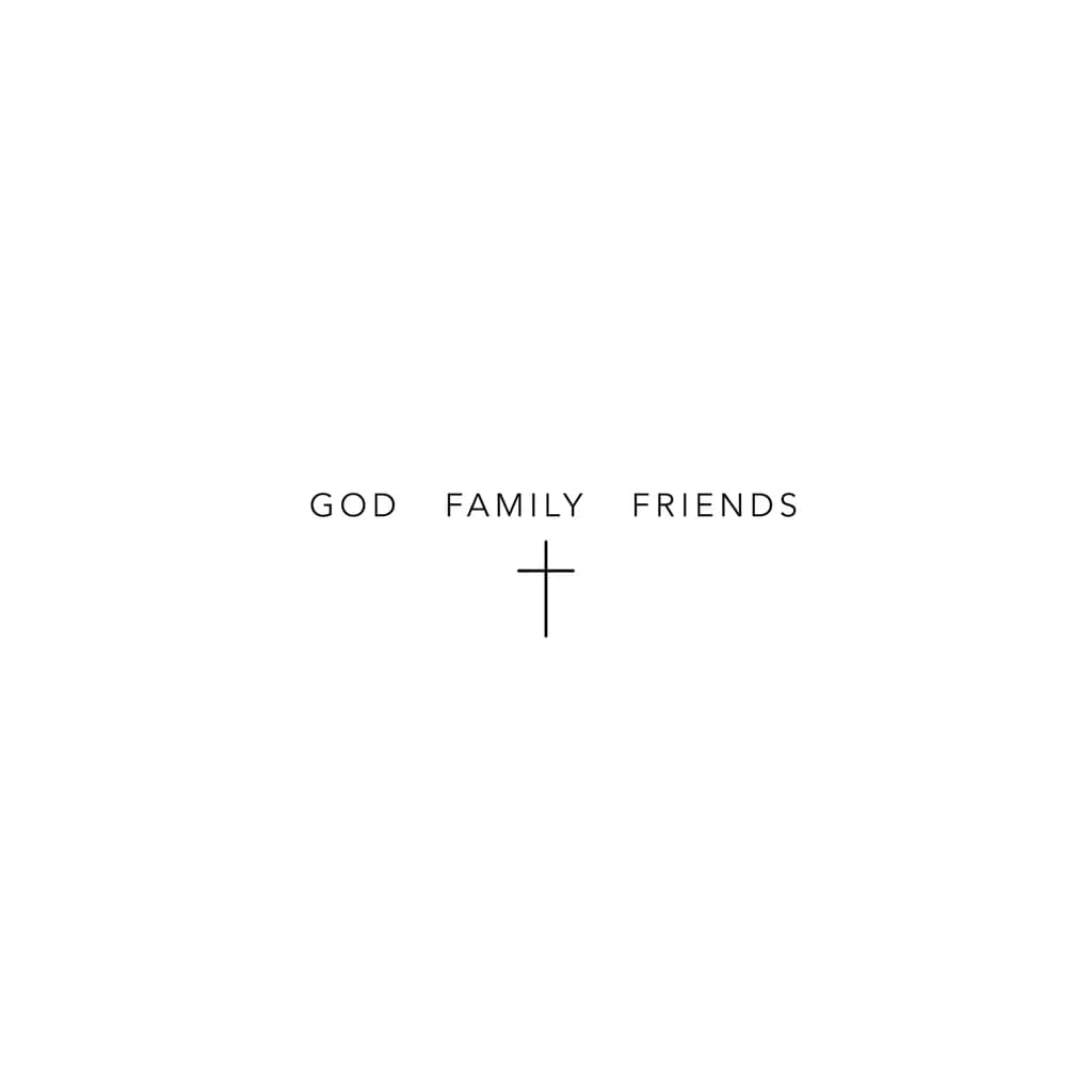 there is a samll cross, with 3 words, god, family, friends.